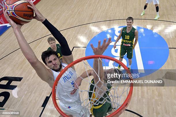 Italy's small forward Alessandro Gentile slams a dunk despite Lithuania's forward Jonas Maciulis d uring the round of 8 basketball match between...