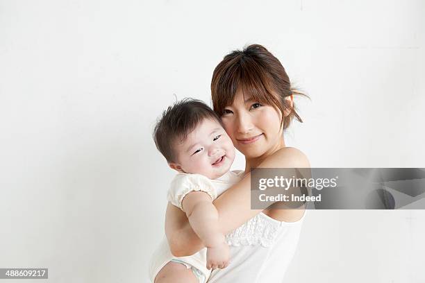 portrait of mother and baby boy - baby on white stock-fotos und bilder