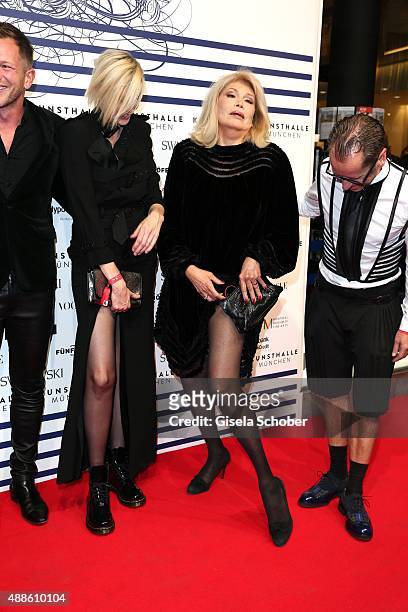 Nadja Auermann and Amanda Lear shows her leg, Dr. Roger Diederen, Director Kunsthalle Muenchen during the opening of the exhibition Jean Paul...
