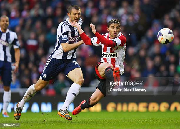 Fabio Borini of Sunderland beats Gareth McAuley of West Bromwich Albion to score their second goal during the Barclays Premier League match between...