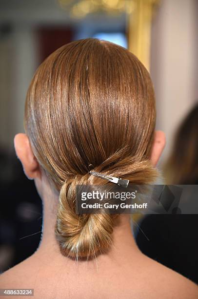 Model prepares, hair detail, backstage prior to the Marchesa fashion show during Spring 2016 New York Fashion Week at St. Regis Hotel on September...