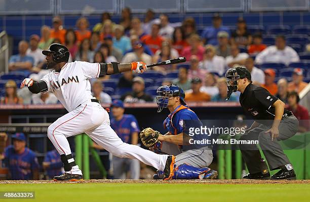 Marcell Ozuna of the Miami Marlins hits a walk off sacrafice fly during a game against the New York Mets at Marlins Park on May 7, 2014 in Miami,...