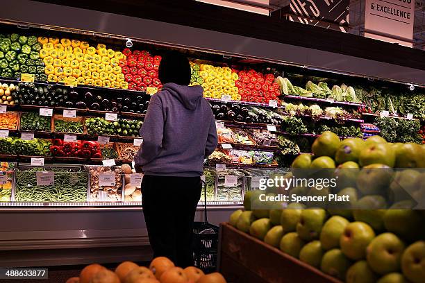 Person shops in Whole Foods Market in the Brooklyn borough on May 7, 2014 in New York City. Whole Foods Market, an upscale grocery store that sells...