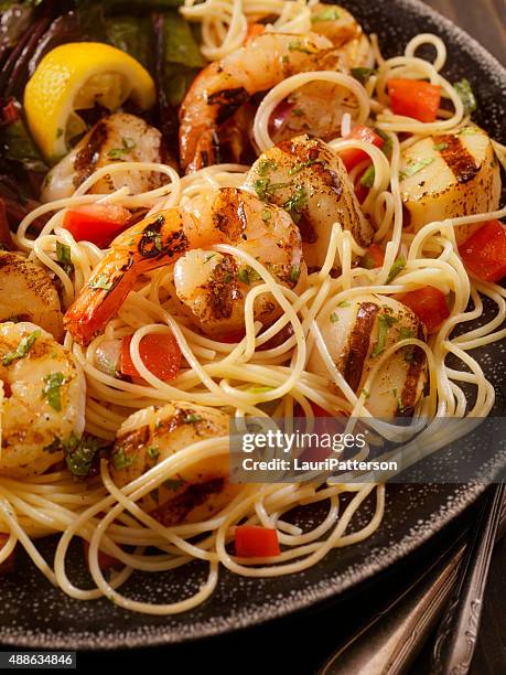 bbq shrimp and scallops with pasta - scampi stock pictures, royalty-free photos & images