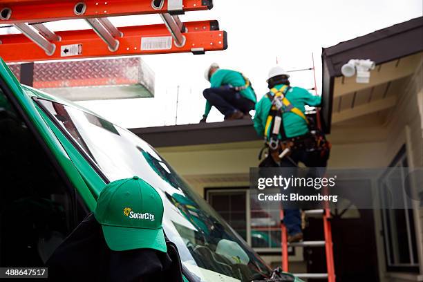 SolarCity Corp. Employees install solar panels on the roof of a home in the Eagle Rock neighborhood of Los Angeles, California, U.S., on Wednesday,...