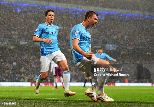 Edin Dzeko of Manchester City celebrates scoring the opening goal with Samir Nasri during the Barclays Premier League match between Manchester City...