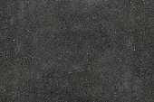 Real asphalt texture background. Coloured dark black asphalt pattern.