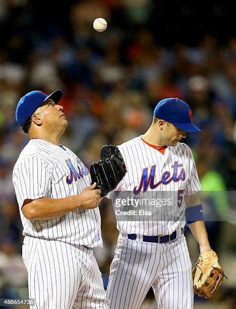 Bartolo Colon of the New York Mets reacts while teammate David Wright stands by as Colon is about to be pulled from the game in the sixth inning...
