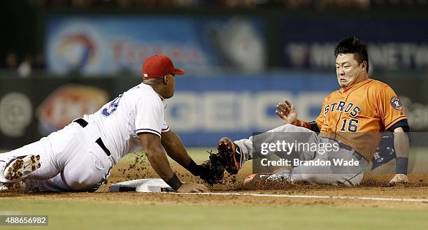 Adrian Beltre of the Texas Rangers tags out Hank Conger of the Houston Astros at third during the third inning of a baseball game against the Houston...