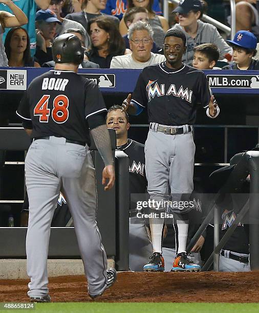 Justin Bour of the Miami Marlins is congratulated by teammate Dee Gordon after Bour hit a solo home run in the eighth inning against the New York...