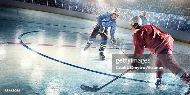 ice hockey players in action - shooting puck stock pictures, royalty-free photos & images