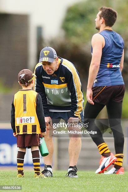 Hawks head coach Alastair Clarkson talks to a young fan during a Hawthorn Hawks AFL training session at Waverley Park on September 17, 2015 in...