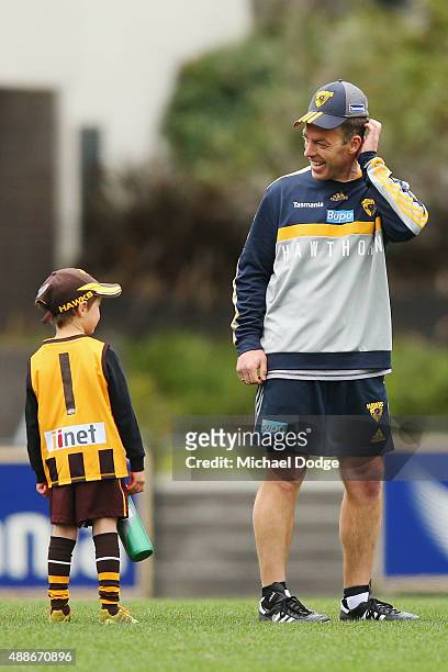 Hawks head coach Alastair Clarkson reacts to a young fan during a Hawthorn Hawks AFL training session at Waverley Park on September 17, 2015 in...