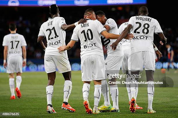 Foued Kadir of Rennes celebrates with team mates after scoring his teams first goal during the Ligue 1 match between Paris Saint-Germain FC and Stade...