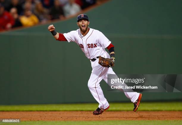 Dustin Pedroia of the Boston Red Sox reacts after throwing the runner out at first base in the fifth inning against the Cincinnati Reds during the...