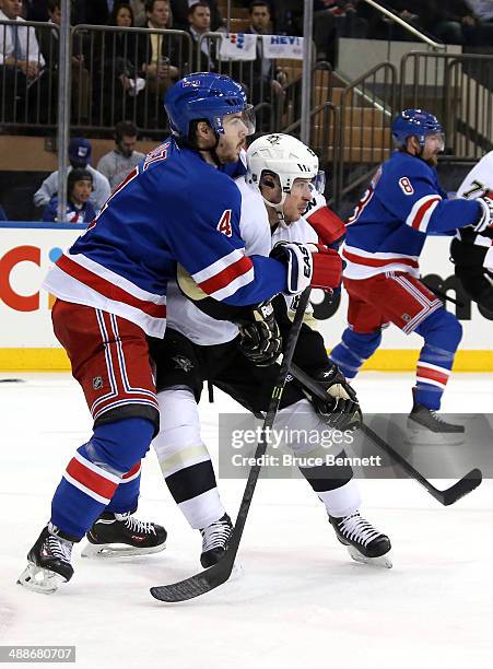 Sidney Crosby of the Pittsburgh Penguins and Raphael Diaz of the New York Rangers battle for position during Game Four of the Second Round in the...