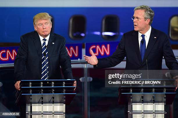 Republican presidential hopefuls Donald Trump looks on as Jeb Bush speaks during the Republican presidential debate at the Ronald Reagan Presidential...