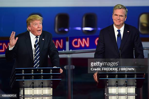 Republican presidential hopeful Donald Trump speaks as Jeb Bush looks on during the Republican presidential debate at the Ronald Reagan Presidential...