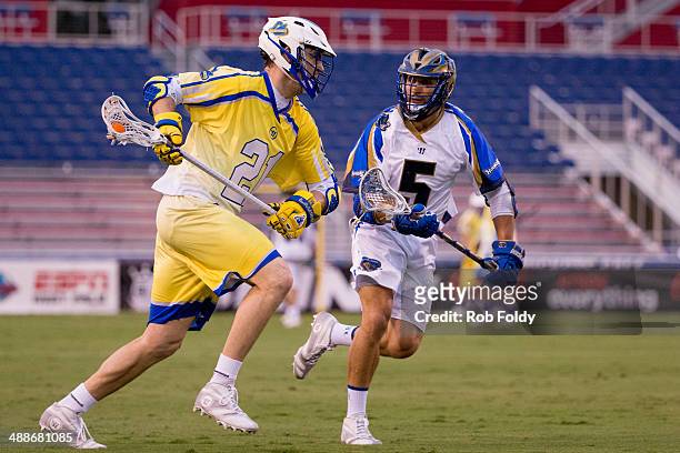 Kevin Crowley of the Florida Launch plays as Casey Cittadino of the Charlotte Hounds defends during the first half of the game at Florida Atlantic...