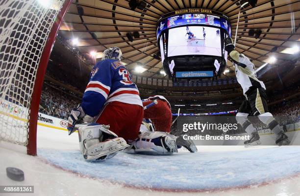 Chris Kunitz celebrates after Evgeni Malkin of the Pittsburgh Penguins scores a goal in the first period against Henrik Lundqvist of the New York...