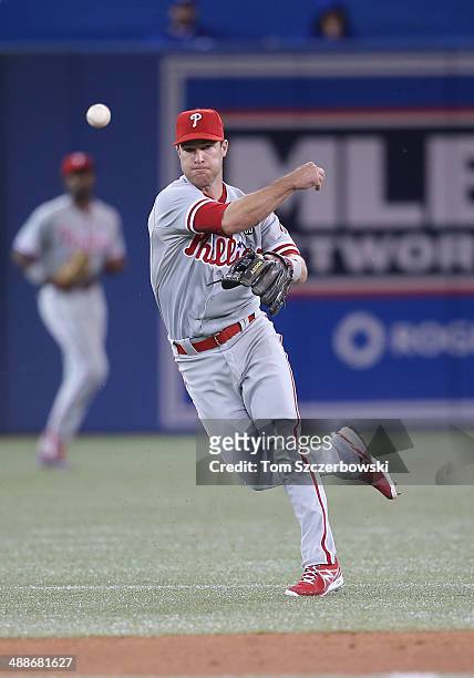 Jayson Nix of the Philadelphia Phillies throws out the baserunner in the sixth inning during MLB game action against the Toronto Blue Jays on May 7,...