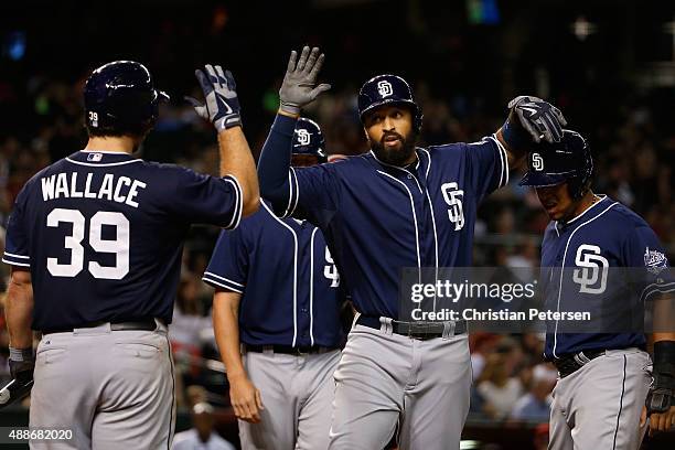 Matt Kemp of the San Diego Padres high fives Brett Wallace, Wil Myers and Yangervis Solarte after Kemp hit a three-run home run against the Arizona...