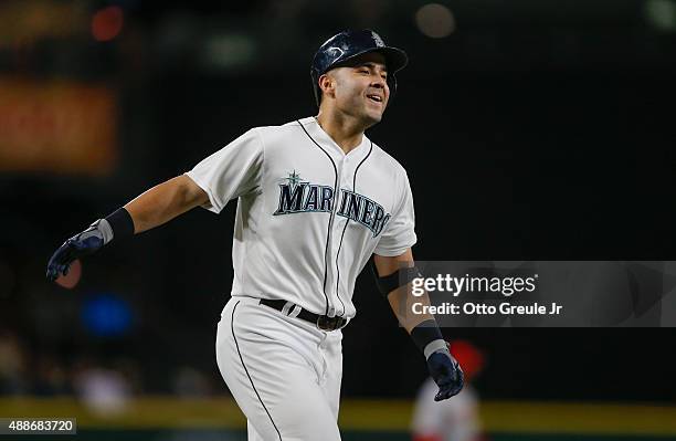 Jesus Montero of the Seattle Mariners rounds the bases after hitting a three-run home run against the Los Angeles Angels of Anaheim in the fourth...