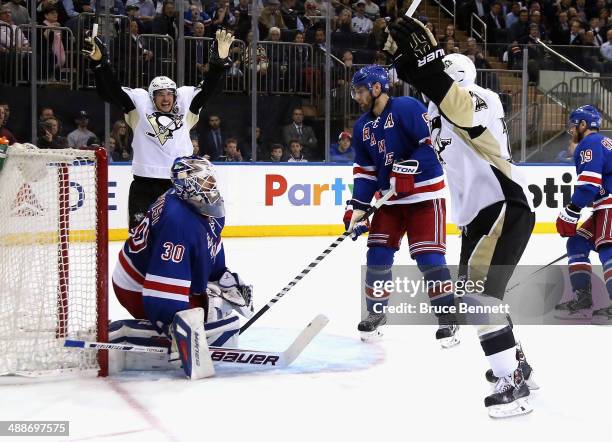 Chris Kunitz of the Pittsburgh Penguins celebrates his third period goal with teammate Sidney Crosby as Henrik Lundqvist and Dan Girardi of the New...