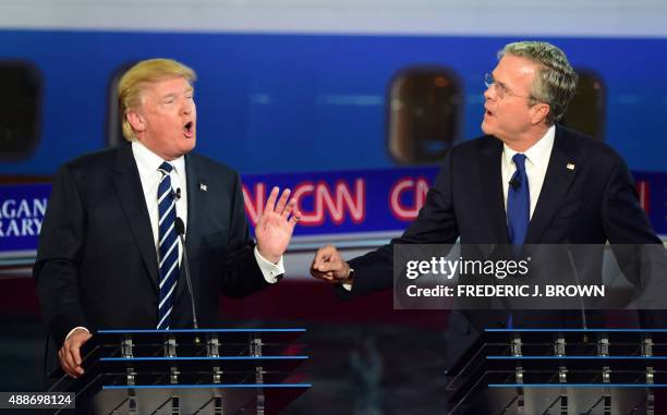 Republican presidential hopefuls Donald Trump and Jeb Bush speak during the Presidential debate at the Ronald Reagan Presidential Library in Simi...