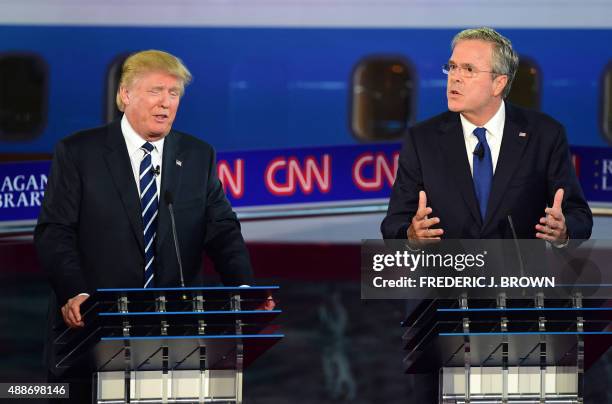 Republican presidential hopefuls Donald Trump and Jeb Bush speak during the Presidential debate at the Ronald Reagan Presidential Library in Simi...