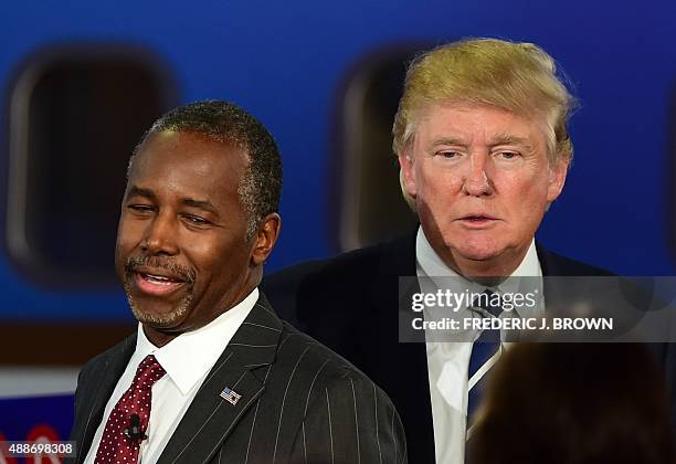 Republican presidential hopefuls Ben Carson and Donald Trump participate in the Republican Presidential Debate at the Ronald Reagan Presidential...