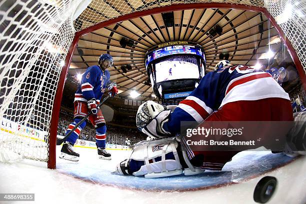 Jussi Jokinen of the Pittsburgh Penguins fires the puck past Henrik Lundqvist of the New York Rangers as Raphael Diaz looks on during Game Four of...