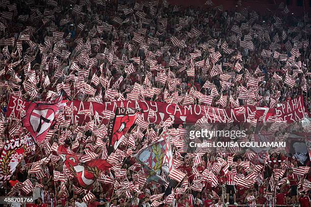Olympiacos' fans cheer for their team during the UEFA Champions League group F football match at the Karaiskaki stadium in Piraeus near Athens on...