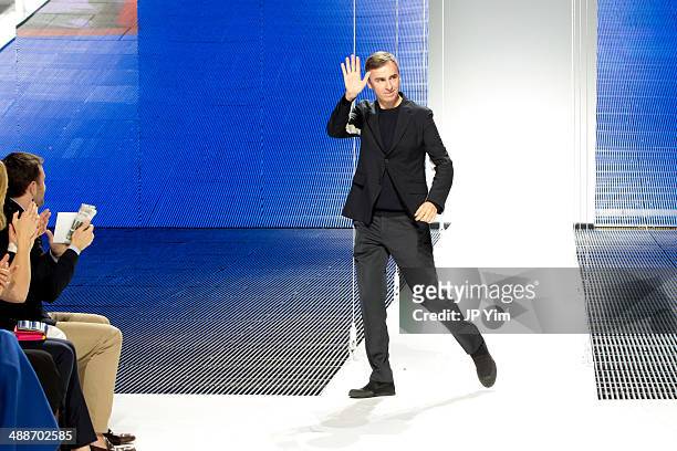 Designer Raf Simons walks the runway at the conclusion of the Christian Dior Cruise 2015 show at Brooklyn Navy Yard on May 7, 2014 in the Brooklyn...