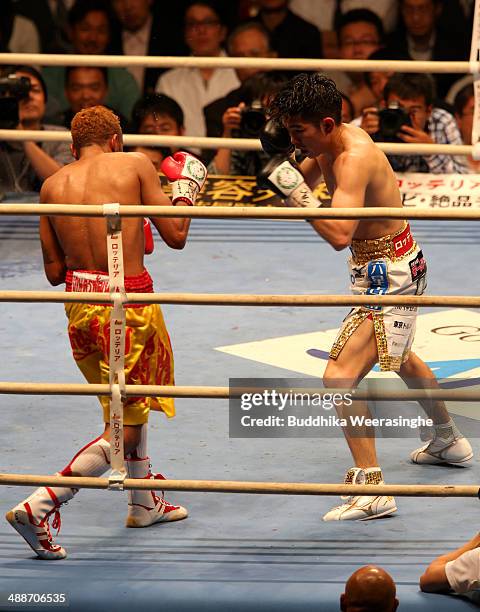 Kazuto Ioka of Japan exchanges punches with Amnat Ruenroeng of Thailand during the IBF minimumweight title bout between Kazuto Ioka of Japan and...