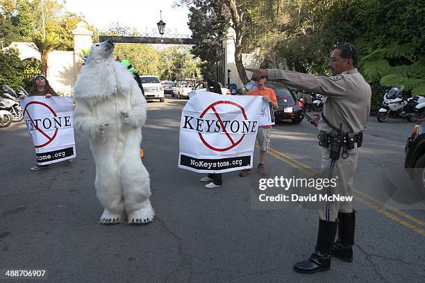 California Highway Patrol officer directs activists opposed to the Keystone XL Canada-to-Texas pipeline project as they enter the the exclusive...