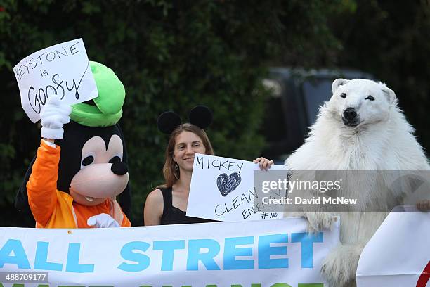 Ileene Anderson, dressed as Goofy; Valeria Love and Andrea Weber, dressed as a polar bear called Frostpaw, rally against the Keystone XL...