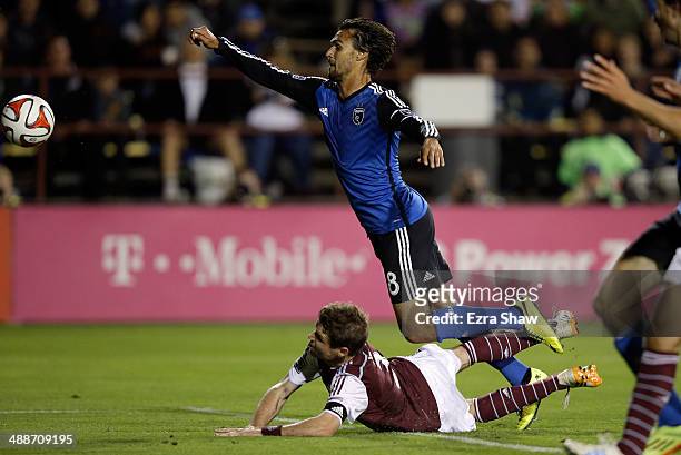 Chris Wondolowski of San Jose Earthquakes trips over Drew Moor of Colorado Rapids as he goes for the ball at Buck Shaw Stadium on May 7, 2014 in...