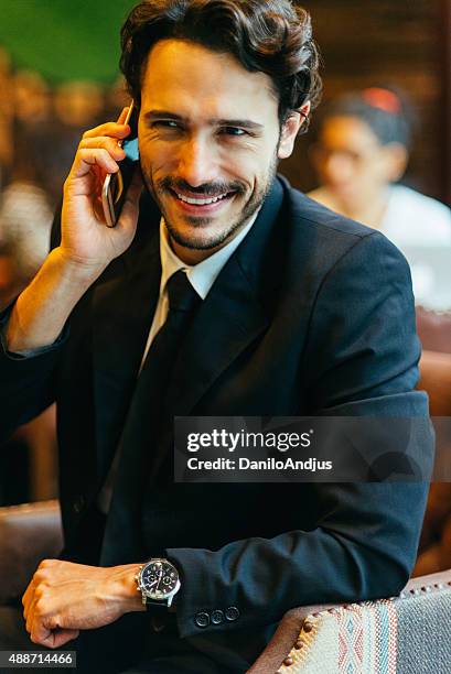 cheerful businessman talking on the phone - brown eyes stock pictures, royalty-free photos & images