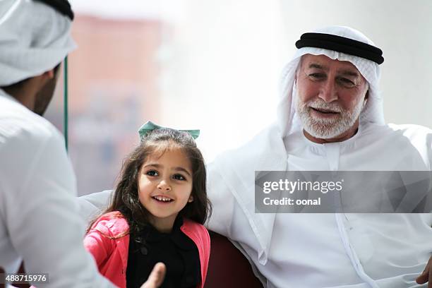 arab family having a conversation - qatari family stockfoto's en -beelden