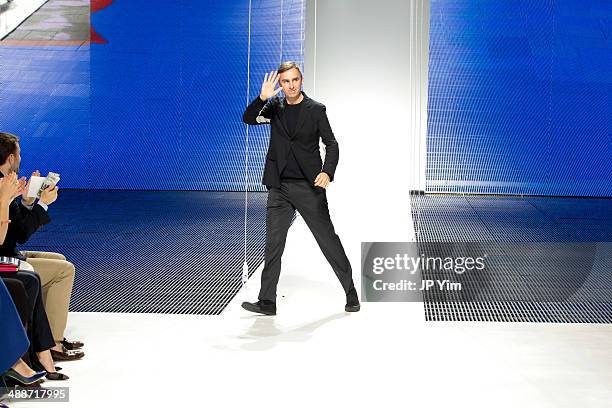 Designer Raf Simons walks the runway at the conclusion of the Christian Dior Cruise 2015 show at Brooklyn Navy Yard on May 7, 2014 in the Brooklyn...