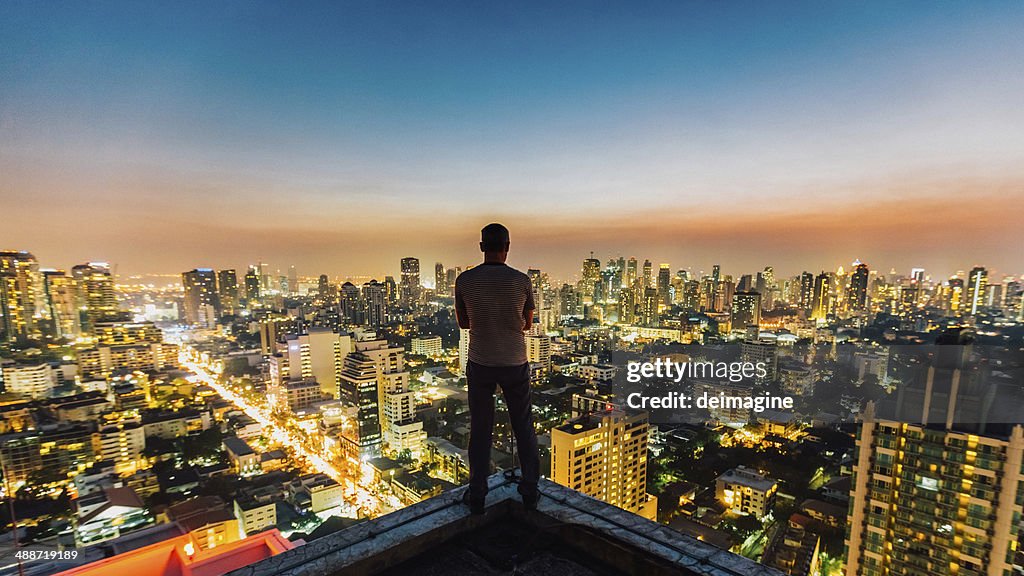 Man on top of skyscraper