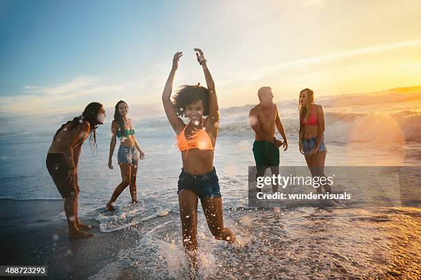 group of friends at the beach - curly waves stock pictures, royalty-free photos & images