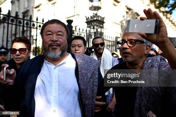Ai Weiwei and Anish Kapoor depart the Royal Academy as they walk through the city as part of a march in solidarity with migrants currently crossing...