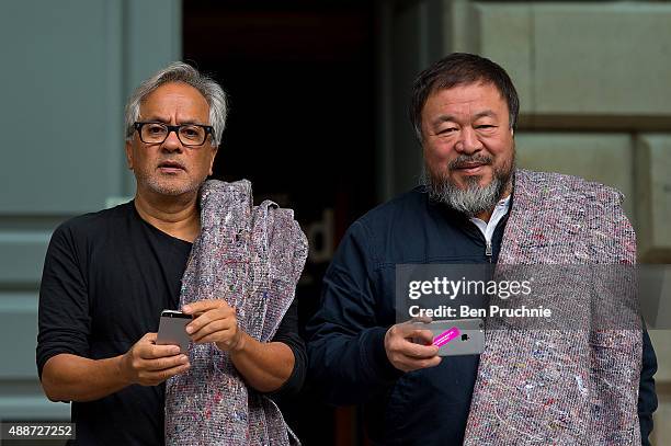 Anish Kapoor and Ai Weiwei pose for members of the press at the Royal Academy ahead of their walk through the city as part of a march in solidarity...