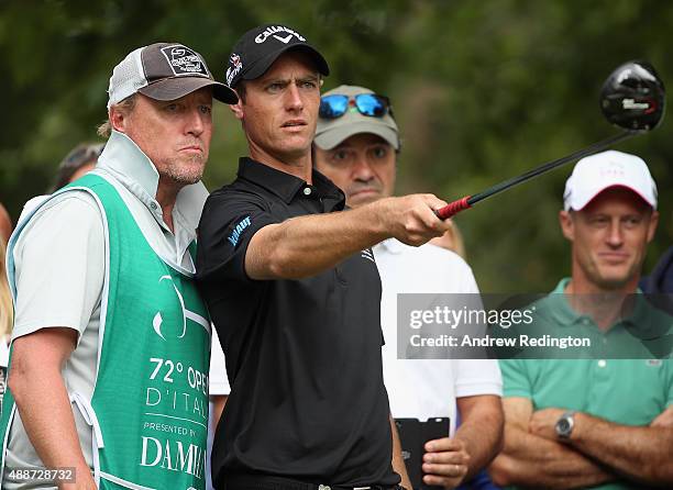 Nicolas Colsaerts of Belgium talks to his caddie Brian Nilsson on the eighth hole during the first round of the 72nd Open d'Italia at Golf Club...