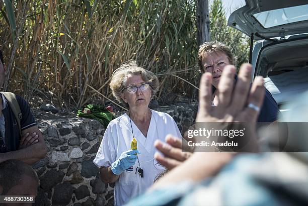 European volunteer doctor is seen near a vehicle to check the wounded and sick refugees in Lesbos Island, Greece on September 17, 2015. European...