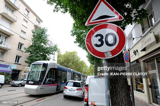 Picture taken on September 15, 2015 in Grenoble, southeastern France, shows a speed limit sign at 30 km per hour. Grenoble district council will...
