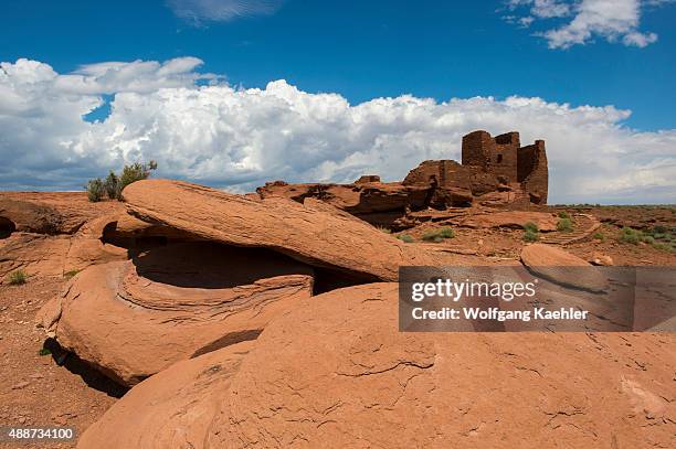 Red rocks in the foreground of the remains of the Wukoki Pueblo in the Wupatki National Monument Park in northern Arizona, USA, where the Northern...