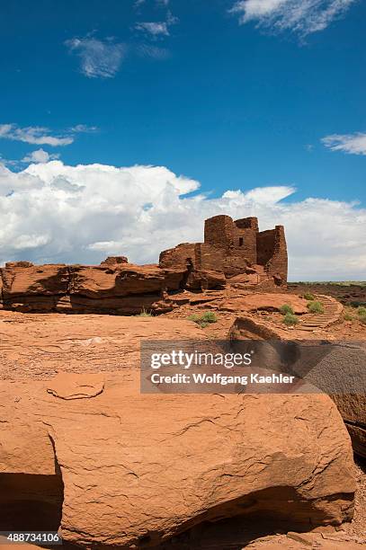 Red rocks in the foreground of the remains of the Wukoki Pueblo in the Wupatki National Monument Park in northern Arizona, USA, where the Northern...